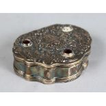 AN EARLY CONTINENTAL SHAPED SILVER BOX with floral repousse cover. 3ins wide.