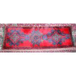 A TURKISH RUG with red and blue pattern. 5ft 7ins x 1ft 11ins.
