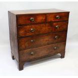 A GEORGIAN MAHOGANY STRAIGHT FRONT CHEST of TWO SHORT AND THREE LONG GRADUATED DRAWERS with oval