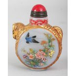 AN UNUSUAL CHINESE ENAMELLED & GILDED GLASS SNUFF BOTTLE, in imitation of a partially gilt-bronze