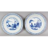 A SMALL PAIR OF CHINESE KANGXI PERIOD BLUE & WHITE PORCELAIN DISHES, circa 1700, each painted with a