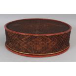 A SOUTH-EAST ASIAN REED WOVEN AND RED LACQUERED CIRCULAR BOX & COVER, with fitted and