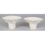 TWO SIMILAR CHINESE KANGXI PERIOD DEHUA BLANC-DE-CHINE PORCELAIN LIBATION CUPS, of rhinoceros horn