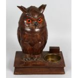 A BLACK FOREST AND CARVED WOOD OWL standing on a book. 8ins high.