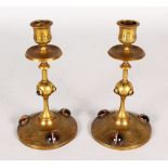 A PAIR OF ISLAMIC DESIGN CANDLESTICKS inset with agate roundels. 7.5ins high.