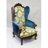 A LARGE VICTORIAN CARVED OAK THRONE CHAIR with padded back, arms and seat.