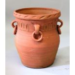 A TERRACOTTA URN, with moulded decoration and ring handles. 1ft 4ins high.