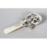 A MINIATURE SILVER HUMPTY DUMPTY RATTLE with mother-of-pearl.