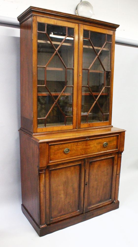 A GOOD EARLY 19TH CENTURY MAHOGANY SECRETAIRE BOOKCASE, the top with glazed astragal doors,