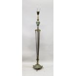 AN EMPIRE REVIVAL BRASS AND ENAMEL FLOOR STANDING LAMP, with urn shaped upper section and rams