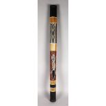 A 20TH CENTURY BAMBOO RAIN STICK with painted crocodile design. 40-inches in length.