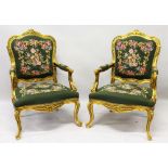 A PAIR OF GILT FRAMED ARMCHAIRS, with needlework upholstery.