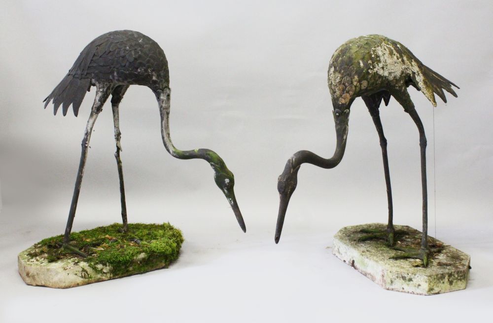 A GOOD PAIR OF JAPANESE LEAD MEIJI STYLE HERONS, on shaped reconstituted stone bases. 3ft 0ins