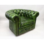 A GREEN LEATHER UPHOLSTERED CHESTERFIELD ARMCHAIR. 2ft 10ins wide.