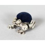 A MINIATURE SILVER FROG PIN CUSHION.