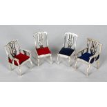 A MINIATURE SILVER SET OF FOUR CHAIRS.