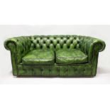A GREEN LEATHER UPHOLSTERED TWO SEATER CHESTERFIELD SETTEE. 5ft 10ins long.