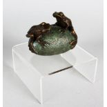 MARTIN NORMAN A small bronze of two frogs on a stone. Signed. 3ins long.