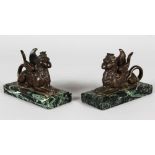 AFTER THE ANTIQUE A PAIR OF BRONZE SPHINX on marble bases. 5ins long.