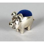 A MINIATURE SILVER PIG PIN CUSHION.