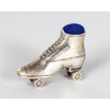 TWO MINIATURE SILVER ROLLER SKATE PIN CUSHIONS.