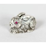 A MINIATURE SILVER SEATED RABBIT with ruby eyes.