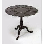 A GEORGE III DESIGN MAHOGANY SUPPER TABLE, the carved, shaped top with dish supports, on a "bird