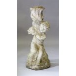 A RECONSTITUTED STONE BIRD BATH BASE, modelled as a cherub holding a dolphin. 2ft high.