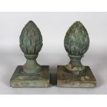 A PAIR OF CARVED WOOD ACORN FINIALS on square bases. 11ins high.