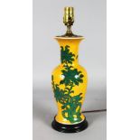 A CHINESE PORCELAIN YELLOW VASE with flowers, as a lamp on a wooden base.