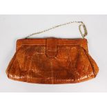 A SNAKESKIN CLUTCH, silver tone hardware, the padded interior lined with brown synthetic fabric,