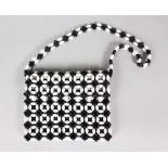 A BLACK AND WHITE BEADED HANDBAG, CIRCA. 1960'S, plastic beads, black synthetic fabric lining and