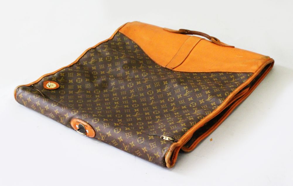 LOUIS VUITTON, A LEATHER AND MONOGRAMMED LEATHER SUIT HOLDER (from the Estate of Ava Astaire