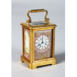 A MINIATURE SEVRES BRASS CARRIAGE CLOCK with pink painted porcelain panels. 2.5ins high.