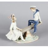 A LLADRO PORCELAIN GROUP "THE SEESAW", a young boy and girl on a seesaw. 11ins long, 9.5ins high.