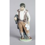 A LLADRO PORCELAIN FIGURE "SANCHO" carrying a cap and sword. 10ins high. No. 6633.