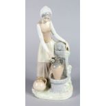 A NAO PORCELAIN FIGURE OF A YOUNG GIRL collecting water at a well. 12ins high.