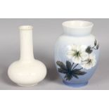 A PLAIN WHITE COPENHAGEN BOTTLE VASE AND VASE painted with flowers, No. 2667. 6.5ins high (2).