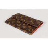 A LOUIS VUITTON LARGE MONOGRAM WALLET.