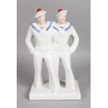 AN ART DECO DESIGN BLUE AND WHITE GROUP OF TWO SAILOR BOYS on a rectangular base. 13ins high.