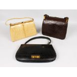 A LADIES BLACK LEATHER CROCODILE HANDBAG, CIRCA. 1960; together with a similar brown and beige