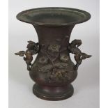 A JAPANESE MEIJI PERIOD BRONZE VASE, with detachable shi-shi handles, the side cast in high relief