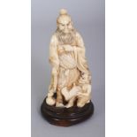 A JAPANESE MEIJI PERIOD IVORY OKIMONO OF SHOKI THE DEMON QUELLER, together with a fixed wood