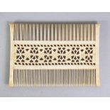 A GOOD QUALITY EARLY 20TH CENTURY EASTERN IVORY COMB, with pierced floral decoration, 3.25in wide