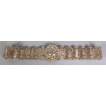 AN EASTERN SILVER-METAL FILIGREE BELT, weighing approx. 394gm, each section decorated with a
