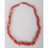 AN AGATE NECKLACE, composed of irregularly formed beads divided by small metal beads, approx. 23in