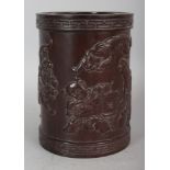 A CHINESE WOOD STYLE BRUSHPOT, decorated in relief with a lantern bearing boy and a group of tigers,