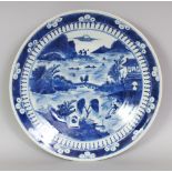 A 19TH CENTURY CHINESE BLUE & WHITE PORCELAIN DISH, the interior painted with a river landscape