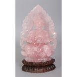 A 20TH CENTURY CHINESE ROSE QUARTZ CARVING OF BUDDHA, together with a fitted wood stand, the