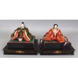 A PAIR OF EARLY 20TH CENTURY JAPANESE OSHIE FABRIC DOLLS OF A SAMURAI & HIS WIFE, together with a